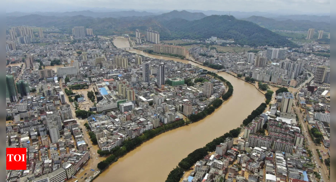 River overflows in southern China, stranding people, turning streets into canals