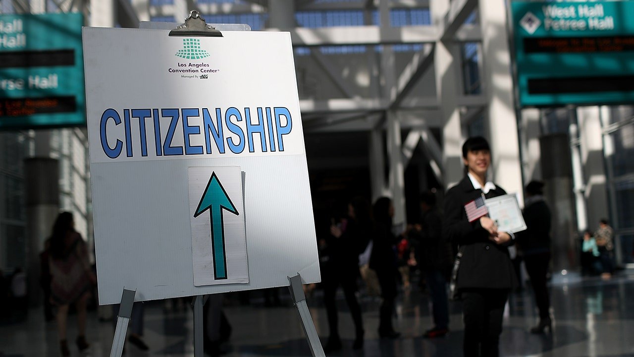 Immigration officer charged with taking bribes for status adjustments