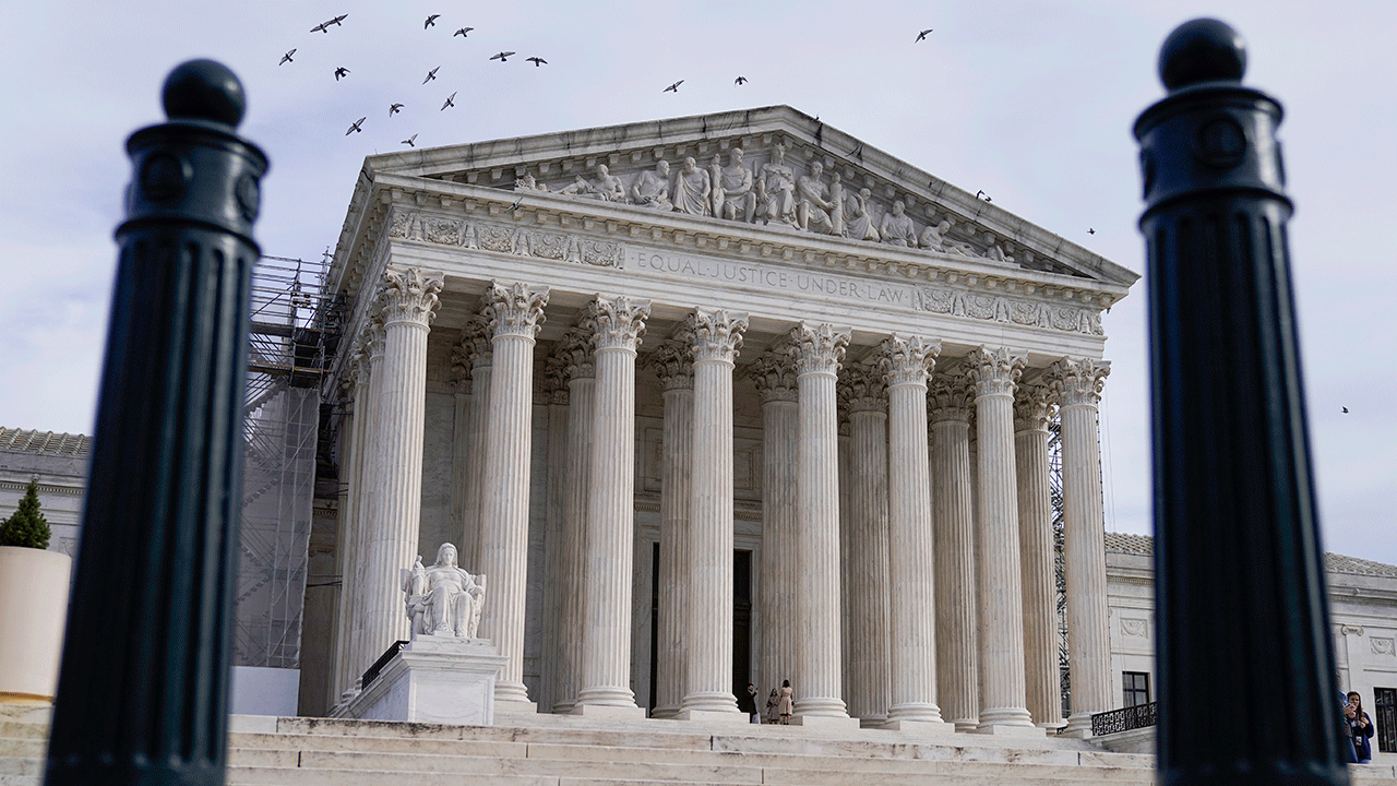 Protesters outside the U.S. Supreme Court support transgender rights