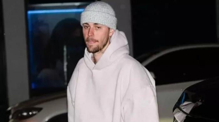 Justin Bieber pokes fun at himself: 'still standing on business'