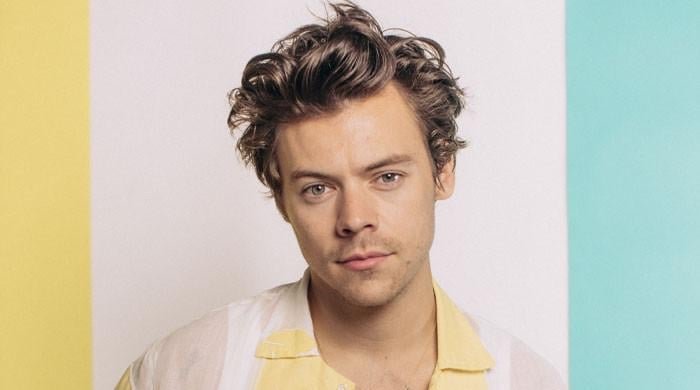 Harry Styles packs on PDA with mystery woman