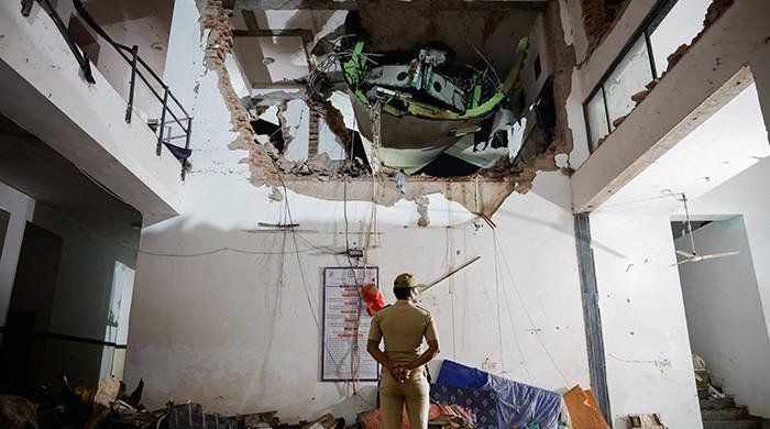 Rescuers search for missing people, aircraft parts after Air India crash kills over 260