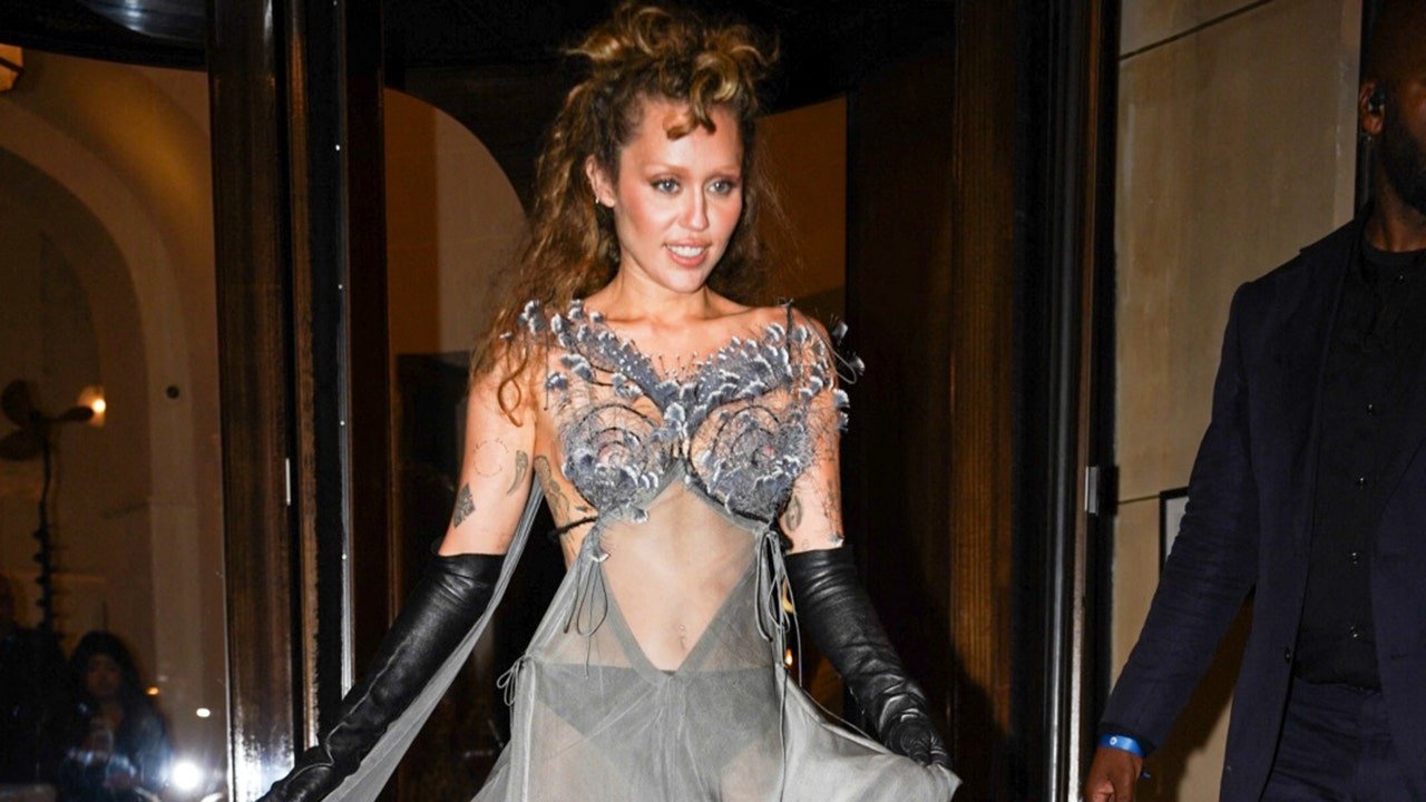 Miley Cyrus shows off toned abs in peacock-feathered sheer dress in Paris