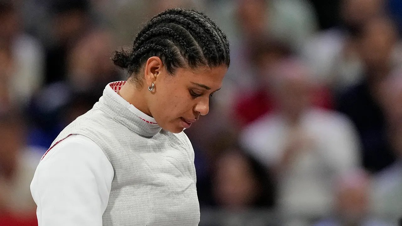 Judges accept French Olympian's kissing defense, clear her of doping violation